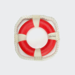 CLOUD7_ Das Apportierspielzeug Rettungsring Floaty ist eine quadratische Rettungsboje mit einem roten kreisförmigen Mittelpunkt, weißem Seil an vier Punkten und CLOUDY-idealem schwimmfähigem Hundering als Apportierspielzeug Hund auf einem schlichten weißen Hintergrund.